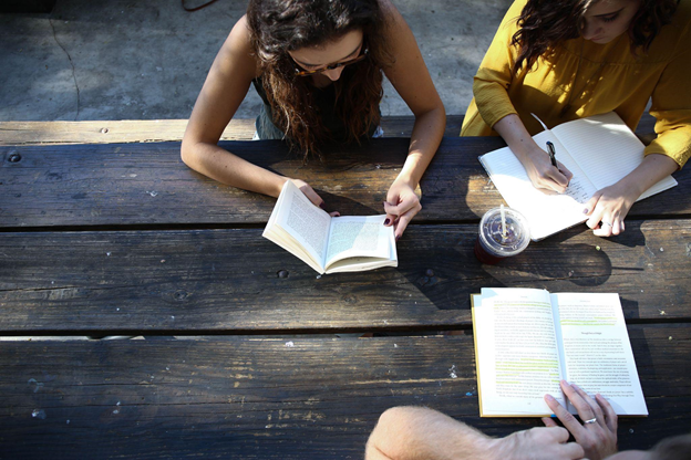 Students of multiple languages studying with textbooks